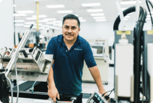 mailing.com team member in front of a printing press