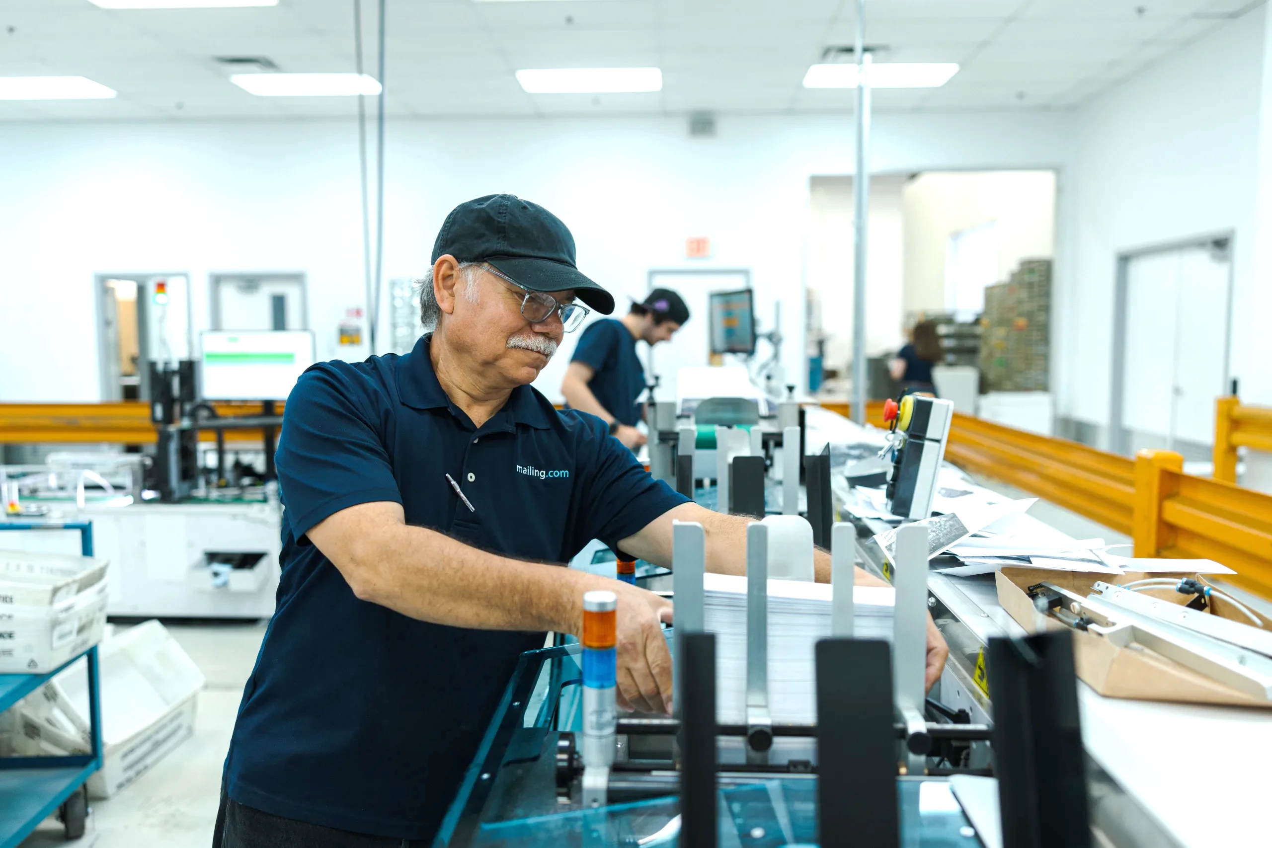 Operator at a mail finishing machine in the mailing.com Tampa, Florida site